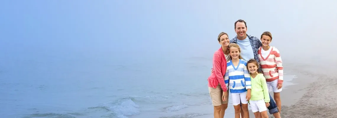 A family together on a foggy beach